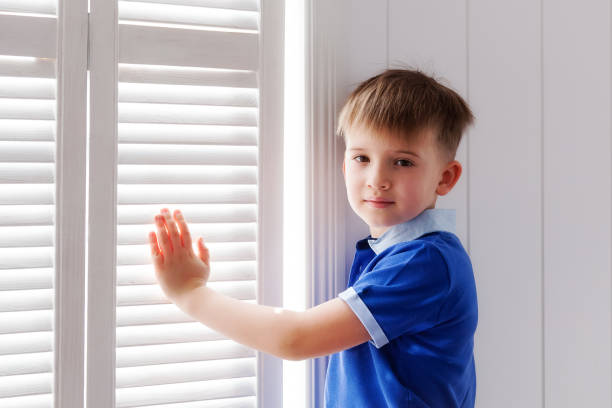 istock Portrait of a boy at a window 665932702