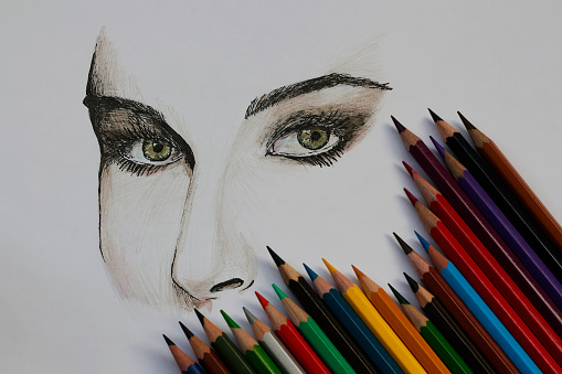 Girl's face drawn with pen and pencil