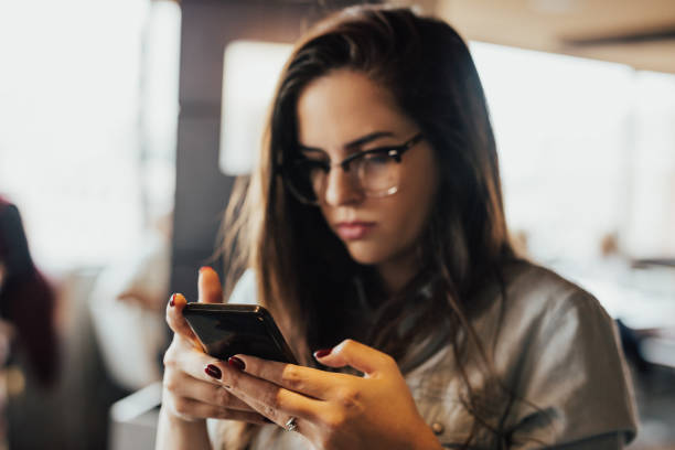 istock Girl with glasses is typing message 665947298