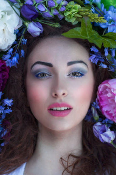 Beautiful girl surrounded by bright coloured flowers