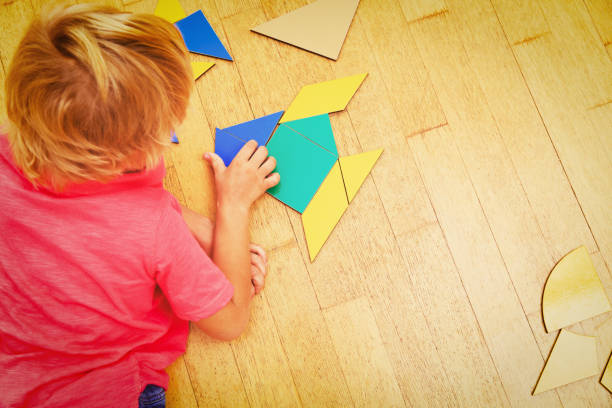 istock little boy playing with puzzle, education and learning 665950804