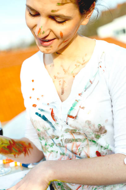 istock Smiling young artistic woman have a fun with colors 665953876