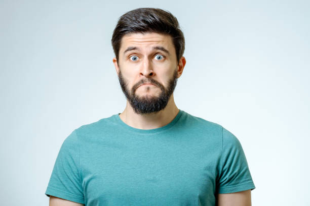 istock Portrait of young man with sad face expression isolated on gray background 665964012