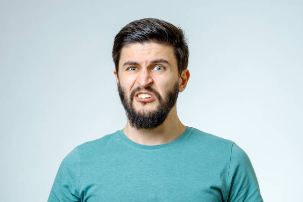 istock Portrait of young man with sad face expression isolated on gray background 665964042