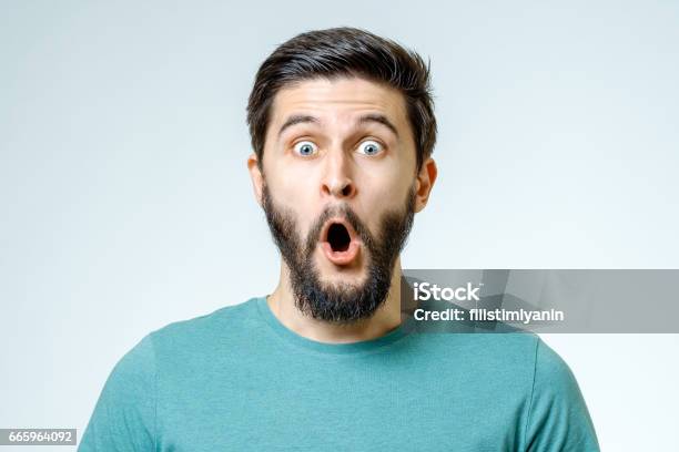 Man With Shocked Amazed Expression Isolated On Gray Background Stock Photo - Download Image Now