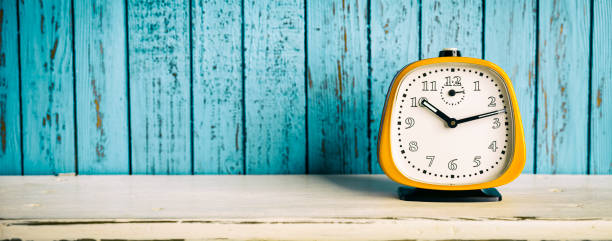 istock Vintage Alarm Clock on White Shelf and pink wood 665979572