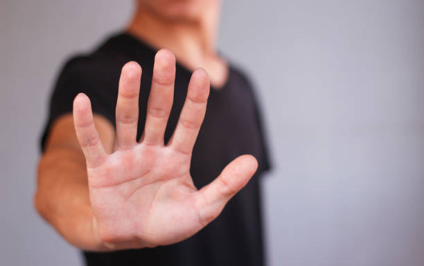 istock Young man in black t shirt shows his hand 665991470