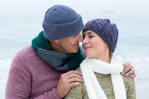 istock Smiling happy couple both wearing scarfs and hats 666003190