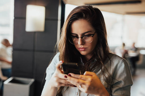 istock Charming young woman using smart phone 666003918