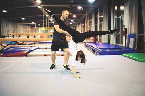 Exercising gymnastic with trainer