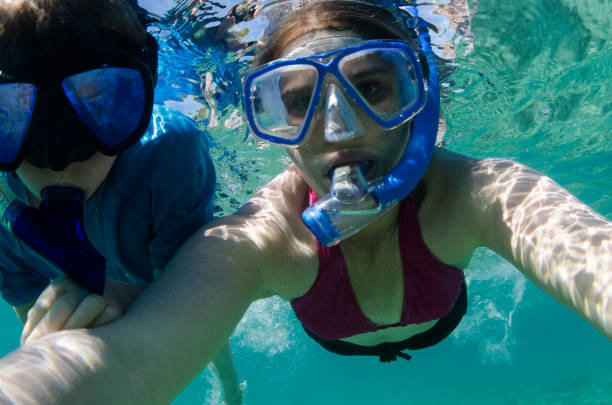 istock Mom and son snorkeling together in hawaii 666012002