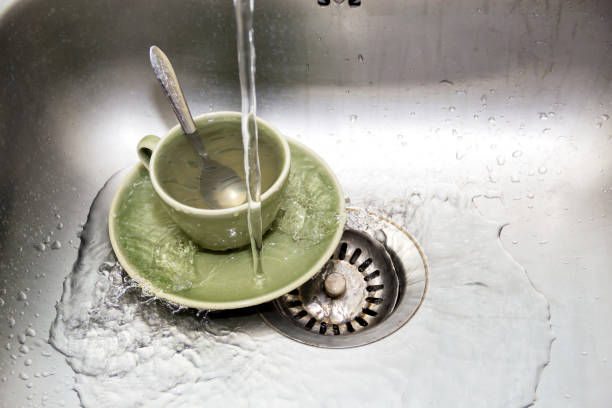 istock Metal faucet in a kitchen, washing ceramic glass 666017970