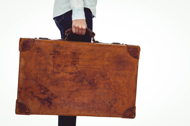istock Mid section of a smiling hipster woman holding suitcase 666018580