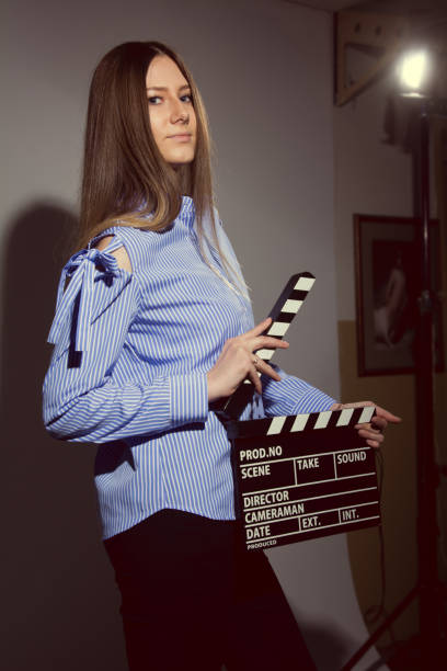 istock Young woman with a movie clapper 666021080
