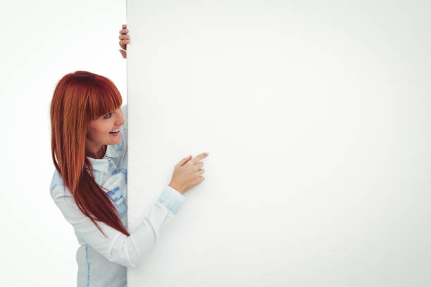 istock Smiling hipster woman behind a white card 666023498