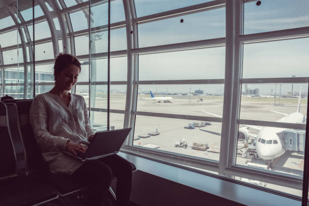 istock Woman using computer at the airport lounge 666023726