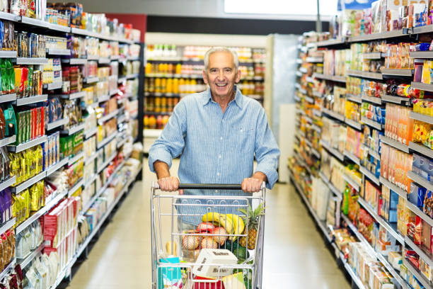 istock Smiling senior man pushing trolley 666024934