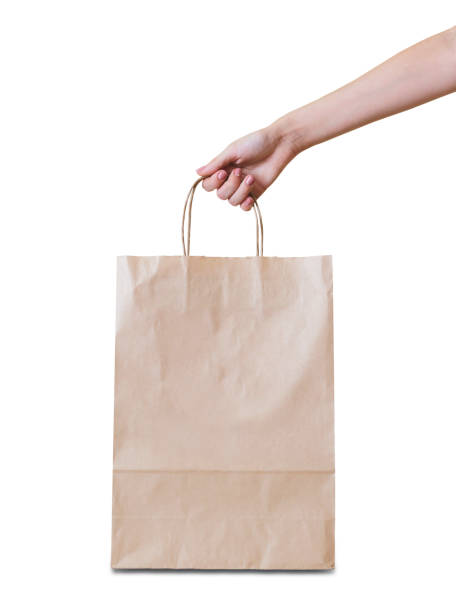 istock Hand holding a paper bag on wooden floor. 666025332