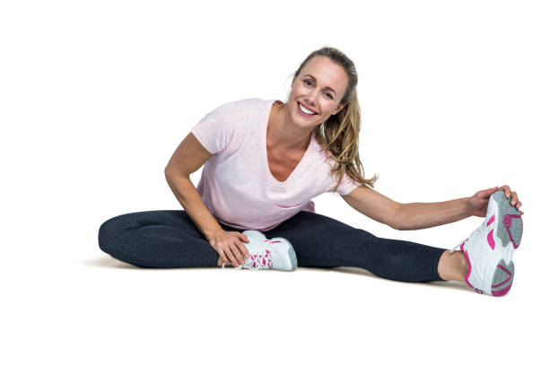 istock Cheerful woman touching toes while exercising 666030586