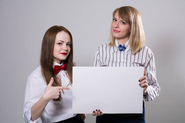 istock Two beautiful girls with a banner 666031342