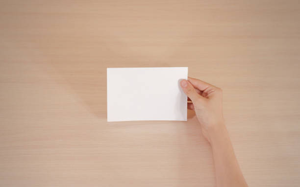 istock Hands holding blank white brochure booklet in the hand. Leaflet presentation. Pamphlet hand man. Show offset paper. Sheet template. Book in hands. Booklet folding design. Fold paper sheet display read 666036392