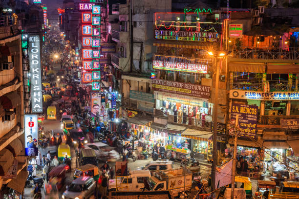 City life- Main Bazar by night, Paharganj, New Delhi, India Main Bazar by night, Paharganj known for its concentration of hotels, lodges, restaurants, dhabas and a wide variety of shops catering to both domestic travellers and foreign tourists, especially backpackers and low-budget travellers. old delhi stock pictures, royalty-free photos & images