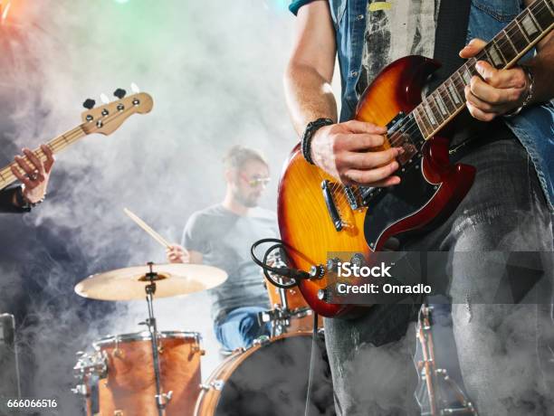 Rock Band Performs On Stage Guitarist Bass Guitar And Drums Stock Photo - Download Image Now