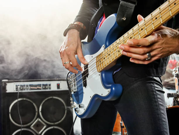 istock Rock band performs on stage. Bassist in the foreground. 666066552