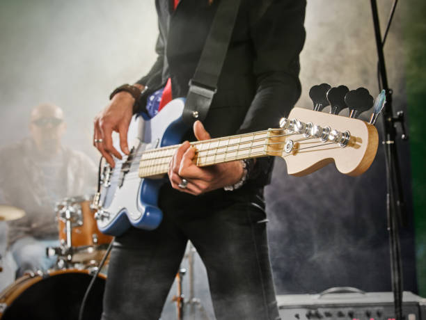 istock Rock band performs on stage. Bassist in the foreground. 666066872