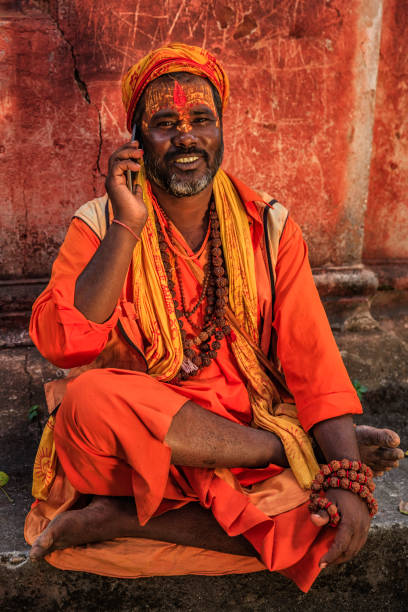 istock Sadhu - indian holyman using mobile phone 666069340