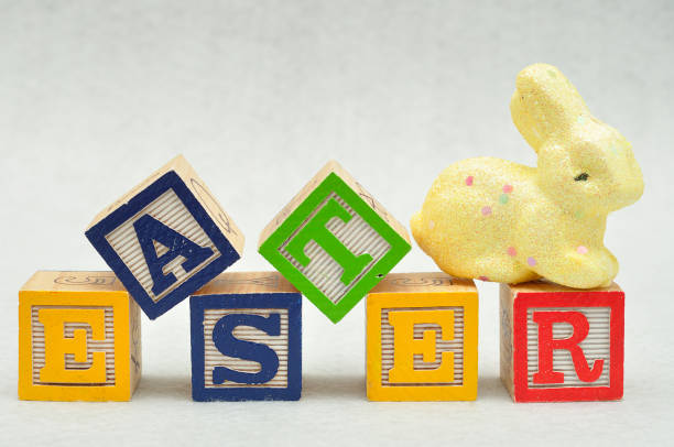 istock Easter spelled with alphabet blocks and a yellow bunny 666069652