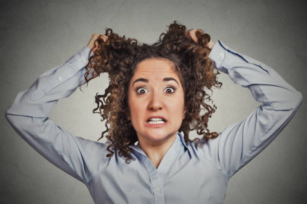 istock skeptical young curly brown hair woman 666069668