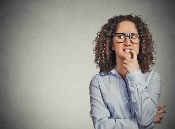 istock skeptical young curly brown hair woman 666071970