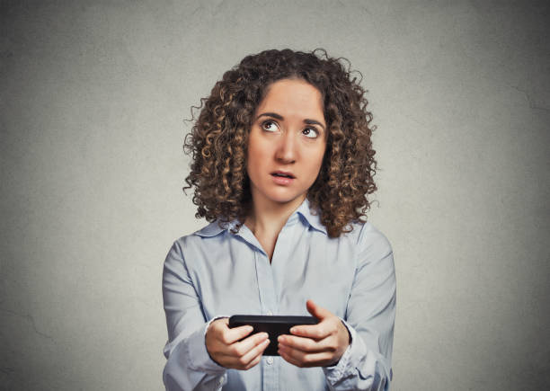 istock confused skeptical unhappy woman with mobile phone 666072076