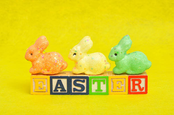 istock Easter spelled with alphabet blocks and a colorful bunnies 666072222