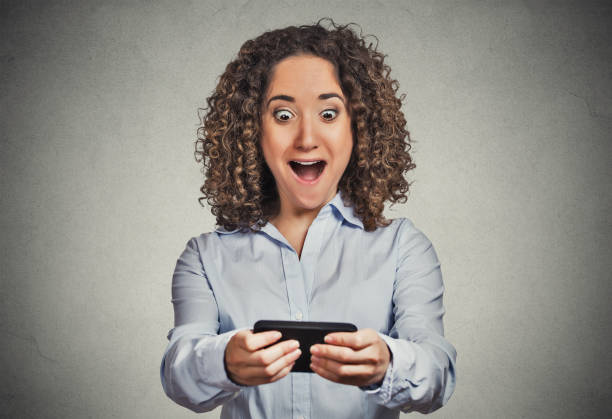 istock happy young woman with mobile phone 666072328