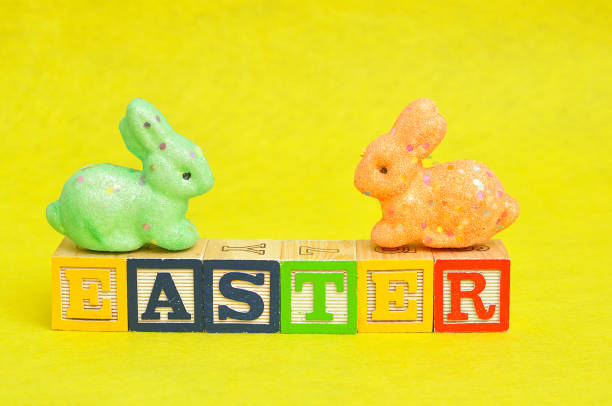 istock Easter spelled with alphabet blocks and a colorful bunnies 666072786