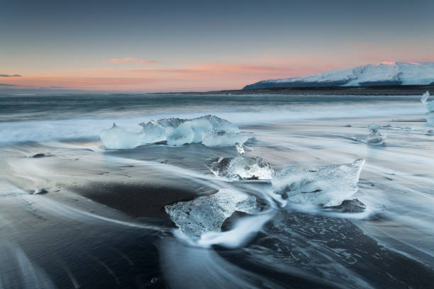 Sunrise in Iceland on the black beach at Jökulsarlon stock photo