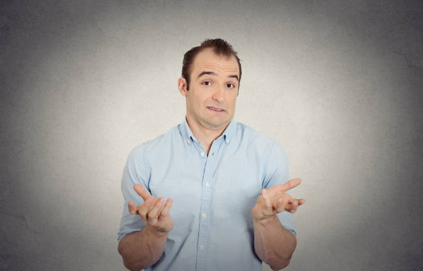 istock dumb clueless funny looking young man arms out asking what do I do now gesturing 666073028