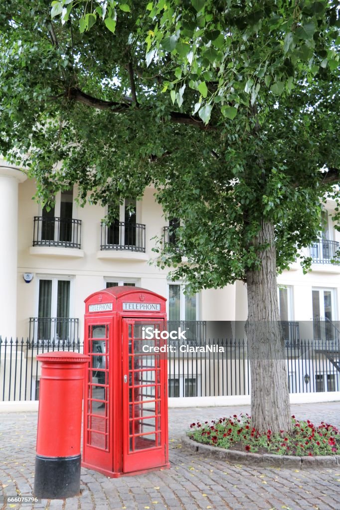 Red telephone cell and mailbox in London, Great Britain Capital Cities Stock Photo