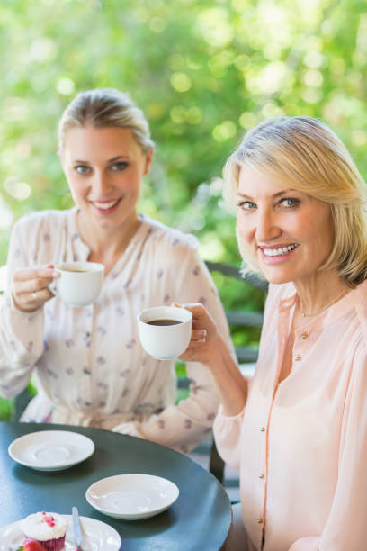 istock Smiling friends enjoying coffee together 666079714