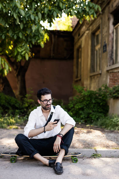 istock Stylish hipster resting on his longboard 666082714