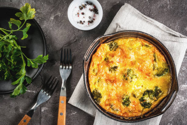 Egg frittata Traditional French food. quiche lorraine. Frittata. Baked in the oven egg omelet with vegetables - broccoli - cheese and greens. Rustic, homemade meal. On a gray concrete table frittata stock pictures, royalty-free photos & images