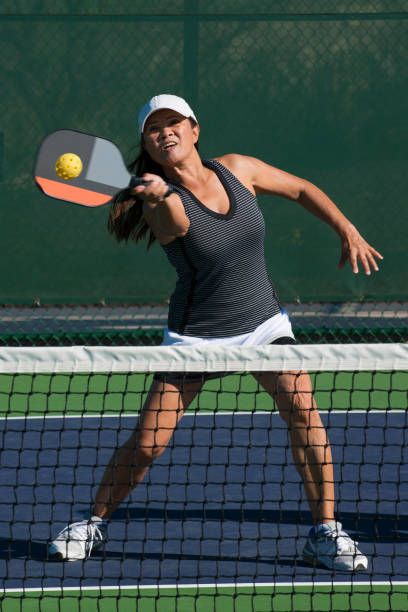 istock Pickleball - Female Player Returning A Shot At The Net 666091866