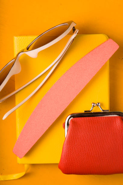 istock Glasses, purse on a notepad on a yellow pop art background 666094438