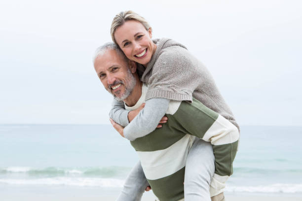 istock Man giving his partner a piggy back 666108568