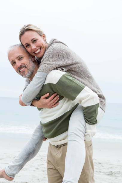 istock Man giving his partner a piggy back 666108632