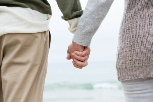istock Close up of a couple holdign hands 666108900