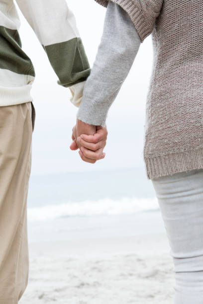 istock Close up of a couple holdign hands 666108970