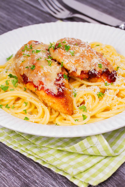 istock Chicken parmesan and pasta. Chicken breasts and spaghetti 666115806